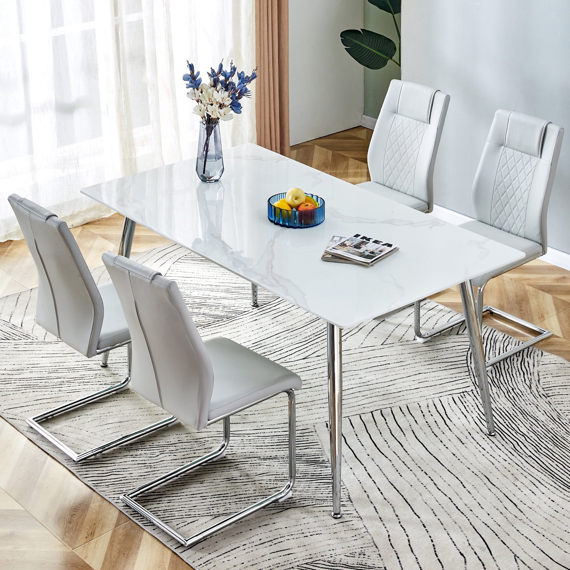 Table and chair set. 1 table and 4 light gray chairs. Rectangular dining table, 0.4 inch white imitation marble tabletop, silver metal table legs. Paired with 4 light gray chairs. 1544 001