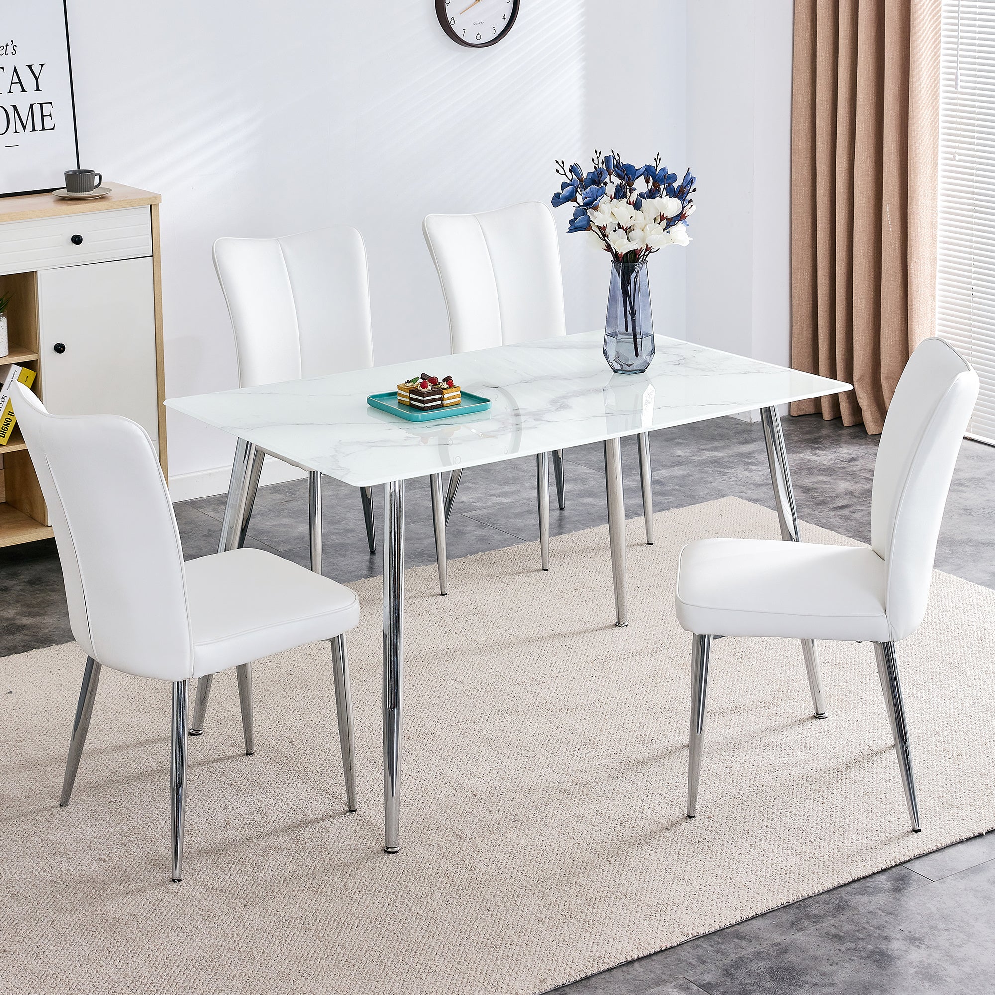 Table and chair set. 1 table with 4 white PU chairs. Modern minimalist rectangular white imitation marble dining table, 0.3 inches thick, with silver metal legs. Paired with 4 PU chairs DT-1544 008