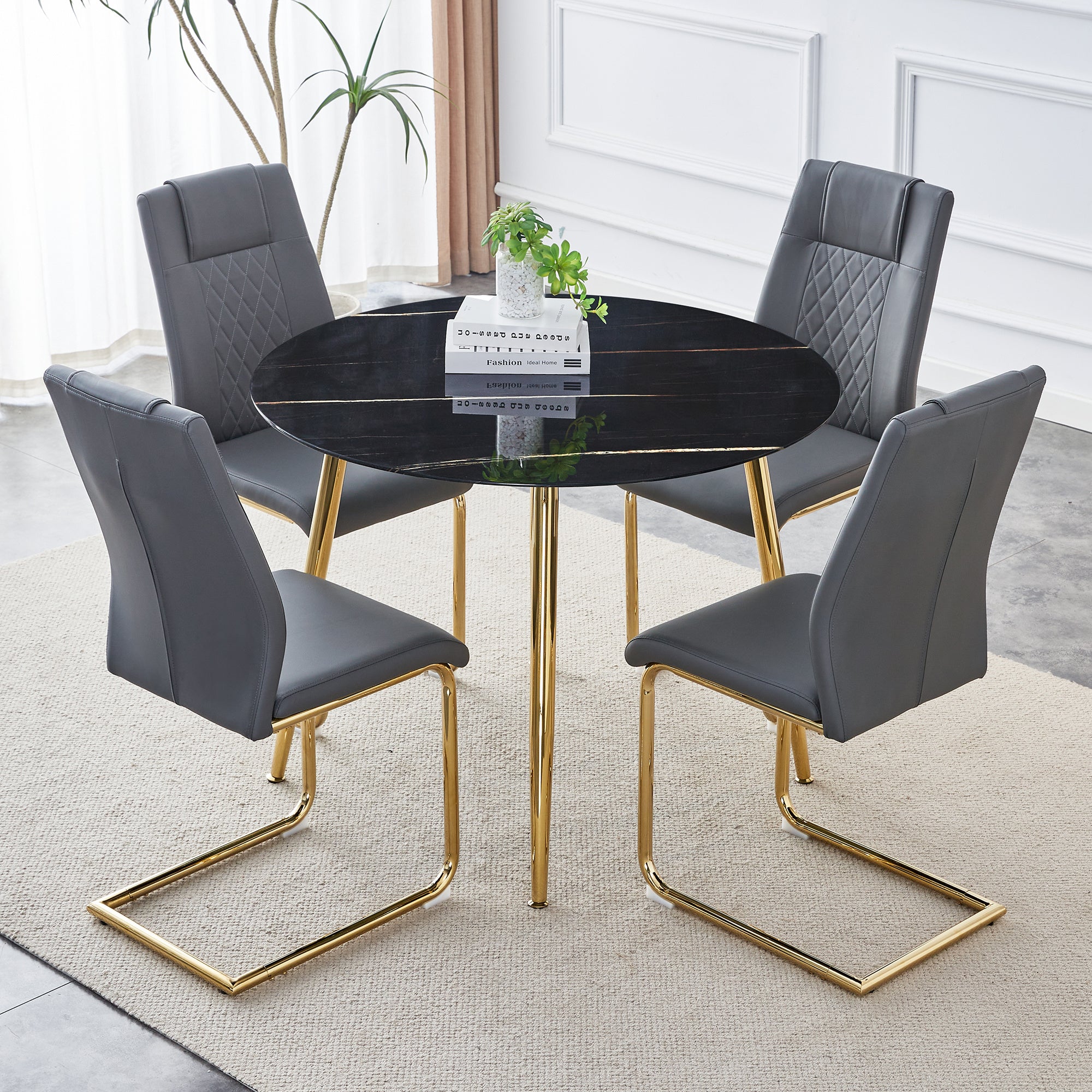 1 table and 4 chairs, a modern minimalist circular dining table with a 40 inch black imitation marble glass tabletop and gold-plated metal legs, and 4 modern gold-plated metal leg chairs.