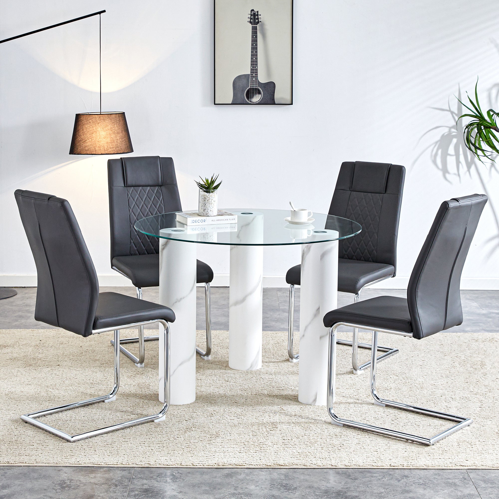 A modern minimalist circular dining table suitable for 6-8 people,Paired with 4 black PU leather cushioned dining chairs with silver metal legs. F-X03 C-001