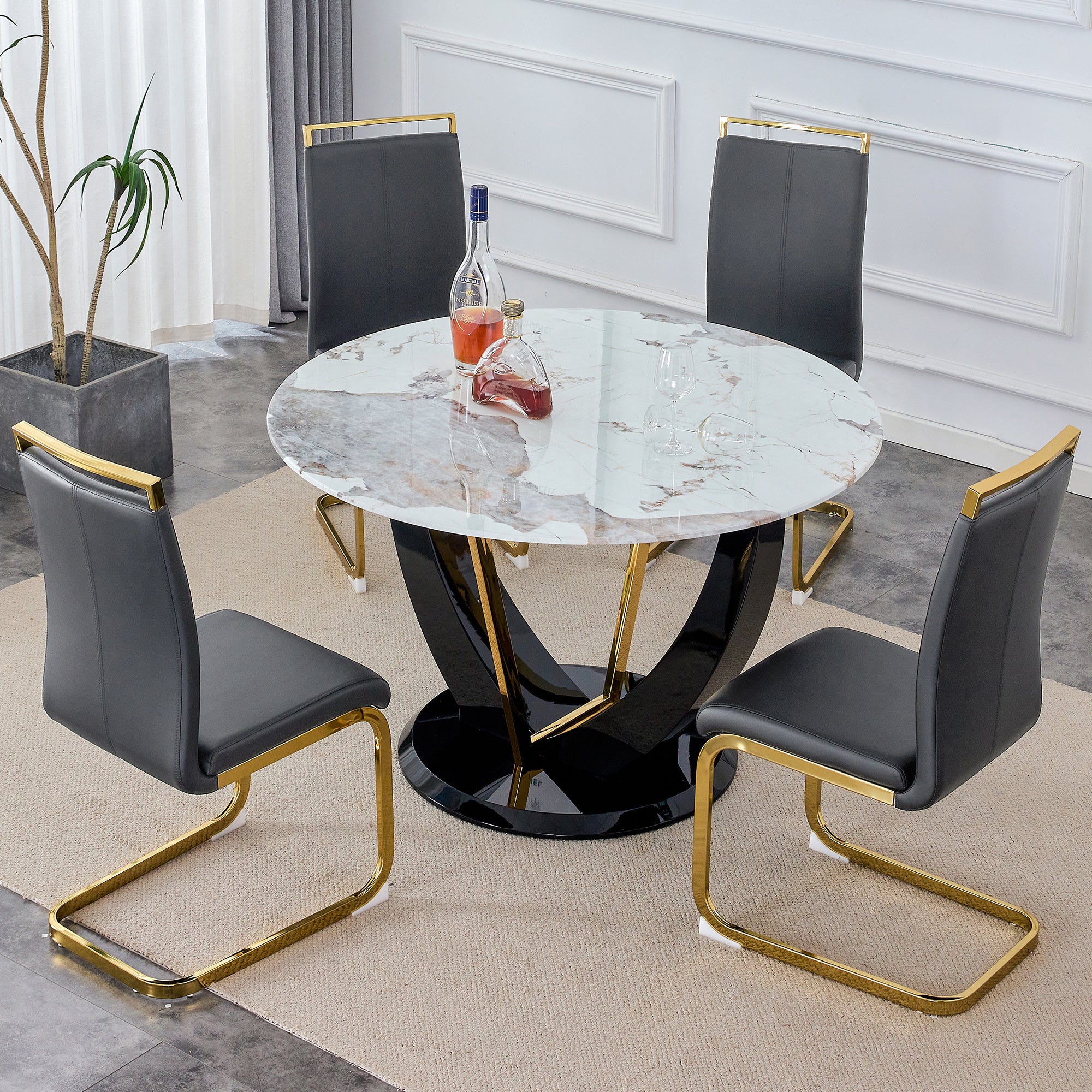 Table and chair set. 1 table and 4 chairs. Round Pandora style stone burning tabletop with black MDF legs. Paired with 4 chairs with PU dark gray cushions and golden legs.908 1162